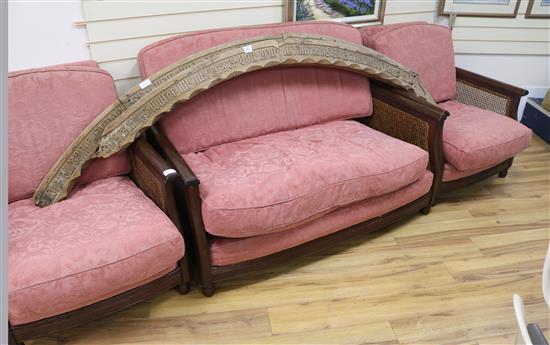 An oak three piece bergere suite, with single caning, settee W.140cm